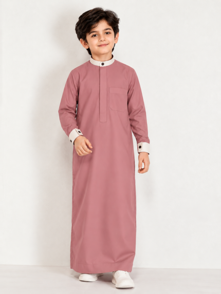 Give your little one a smart and elegant traditional look with the **Isliba Dusty Rose Thobe for Boys**. Featuring a sophisticated dusty rose color, a contrasting cream collar and cuffs, and a clean, minimal design, this thobe is perfect for everyday Islamic wear and special occasions. **Product Features:** - **Elegant Dusty Rose Color:** A modern and stylish shade for boys. - **Minimal Design:** Clean front placket with no embroidery for a simple, refined appearance. - **Contrast Detailing:** Cream stand collar and sleeve cuffs with dark buttons. - **Practical Chest Pocket:** Adds functionality while maintaining a neat look. - **Full Sleeves:** Designed for a classic traditional appearance. - **Versatile Occasion Wear:** Suitable for Eid, Ramadan, Jummah prayers, family gatherings, and festive occasions. **Product Details:** - Brand: Isliba - Product Type: Boys' Thobe / Arabic Jubba - Color: Dusty Rose - Collar: Cream Stand Collar - Sleeves: Full Sleeve - Design: Plain / Minimal - Available Sizes: As per size selection Choose Isliba for a timeless Islamic outfit that combines simplicity, style, and traditional elegance.